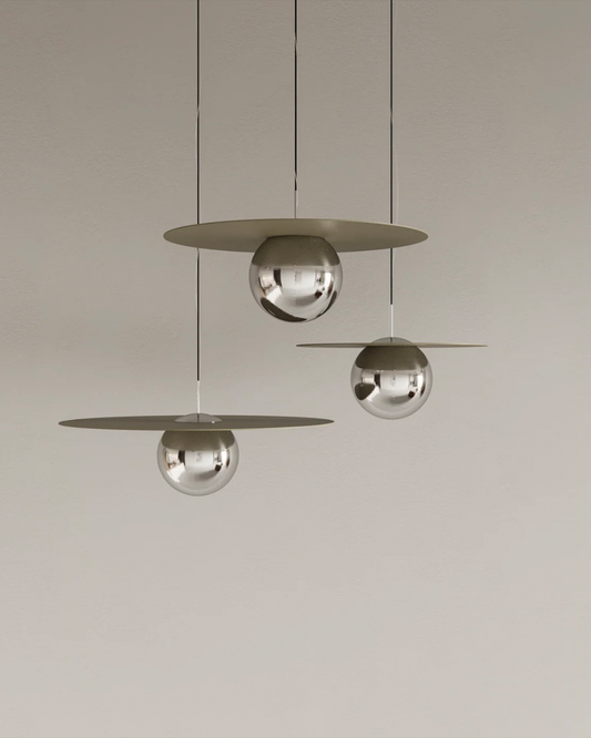 Troika pendant light with three decorative hanging elements creating ambient glow مصباح معلق ترويكا بثلاثة عناصر زخرفية مضيئة بتوهج محيطي