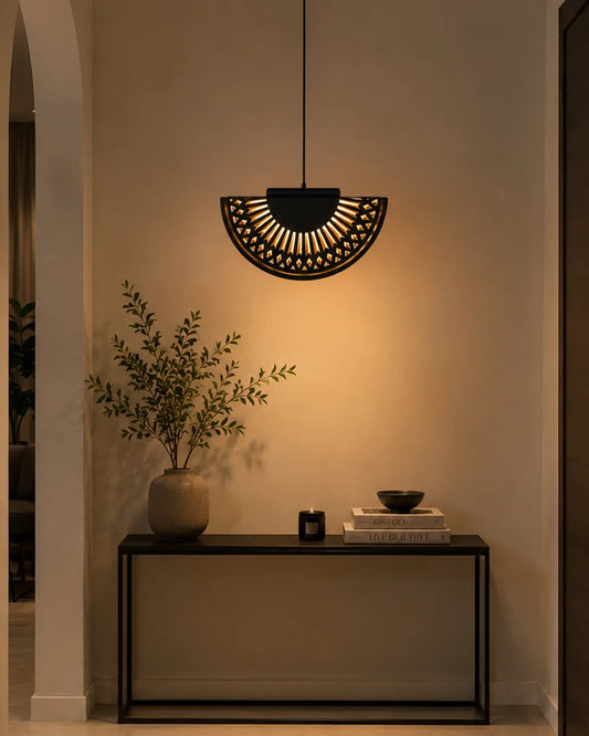 Breeze Pendant in a styled interior, pendant with folds reminiscent of a hand fan (view 2) | دلاية بريز، داخل مساحة منسقة، طيات معدنية مضيئة