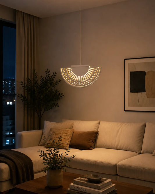 Breeze Pendant in a styled interior, pendant with folds reminiscent of a hand fan (view 1) | دلاية بريز، داخل مساحة منسقة، طيات معدنية مضيئة
