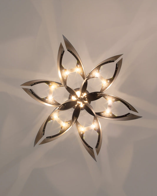 Lotus inspired pendant light with sculptural form casting soft ambient light / إضاءة معلقة بتصميم مستوحى من زهرة اللوتس تبعث إضاءة ناعمة وأنيقة
