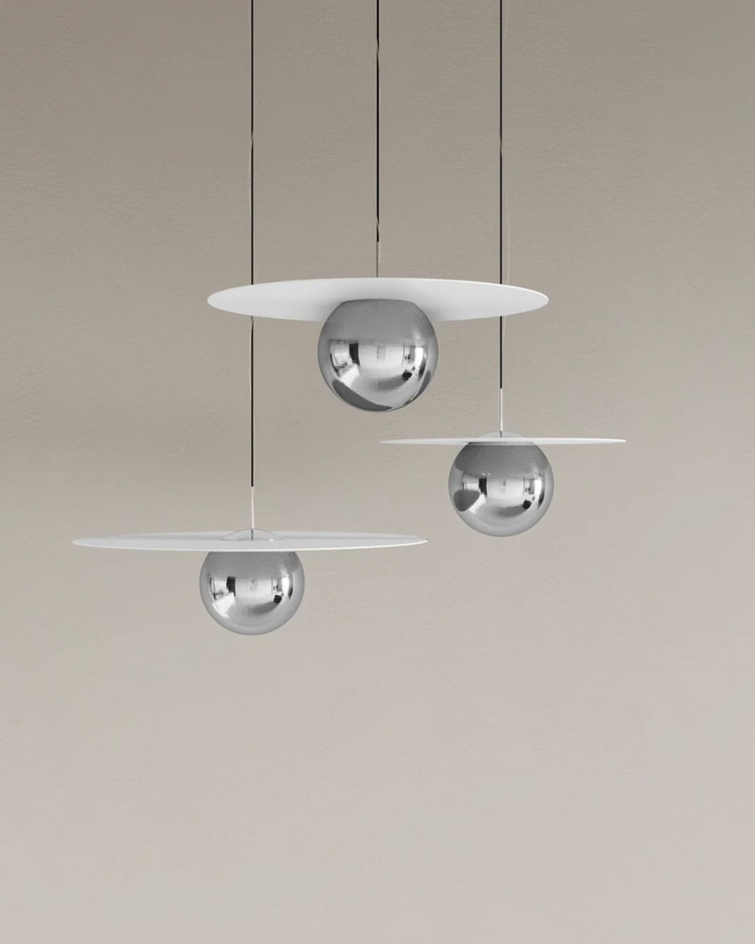 Troika pendant light with three decorative hanging elements creating ambient glow مصباح معلق ترويكا بثلاثة عناصر زخرفية مضيئة بتوهج محيطي