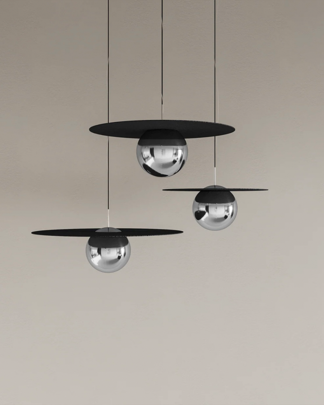 Troika pendant light with three decorative hanging elements creating ambient glow مصباح معلق ترويكا بثلاثة عناصر زخرفية مضيئة بتوهج محيطي