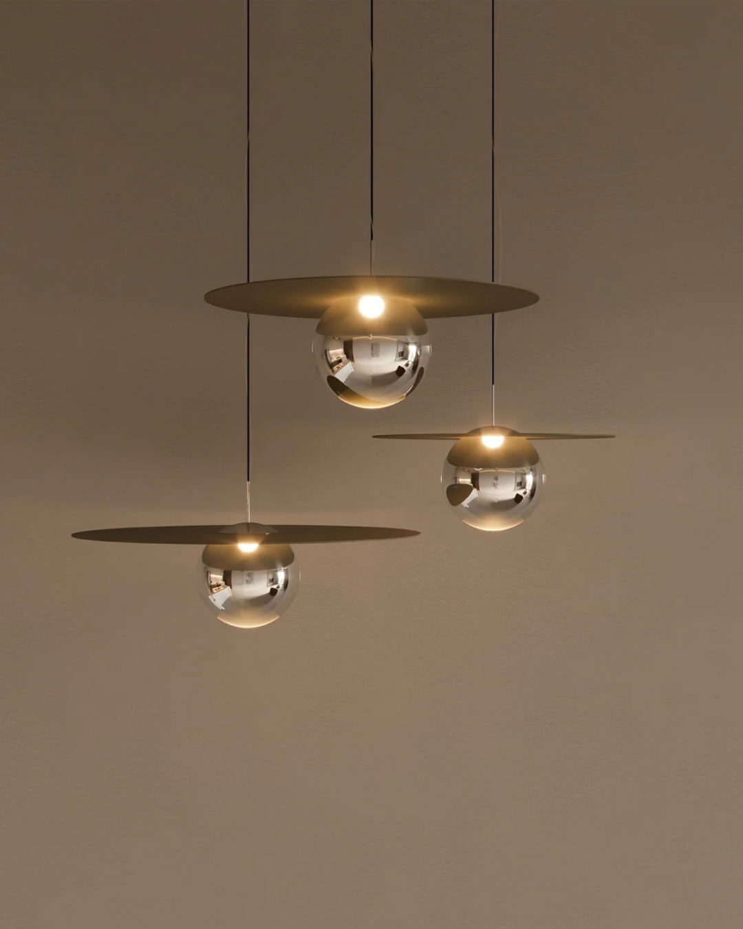 Troika pendant light with three decorative hanging elements creating ambient glow مصباح معلق ترويكا بثلاثة عناصر زخرفية مضيئة بتوهج محيطي