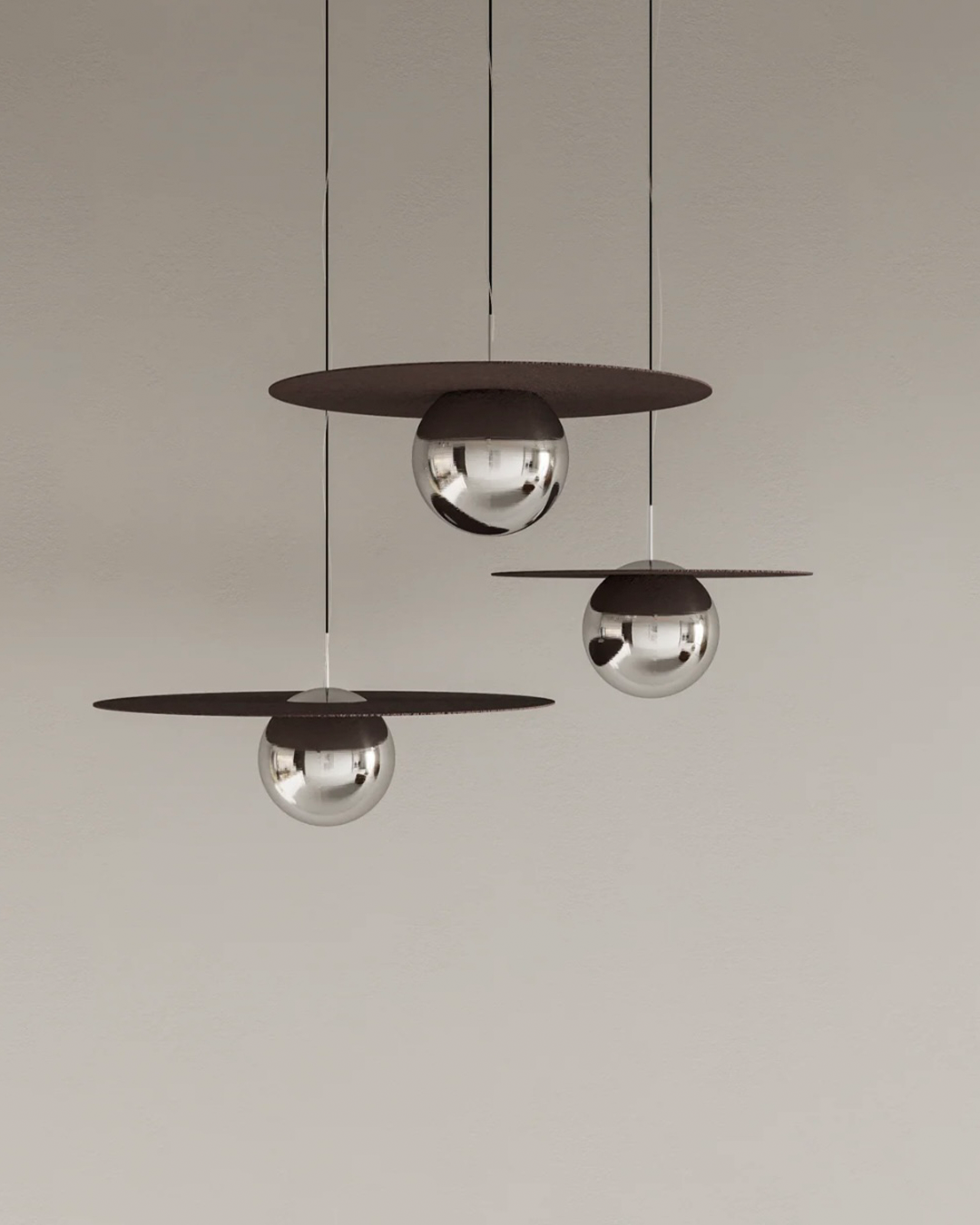Troika pendant light with three decorative hanging elements creating ambient glow مصباح معلق ترويكا بثلاثة عناصر زخرفية مضيئة بتوهج محيطي