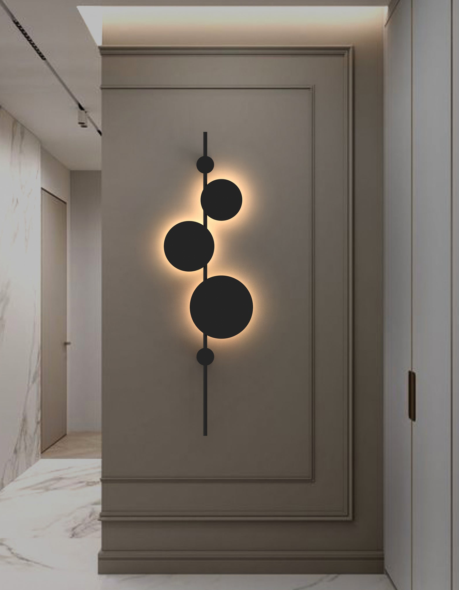 Vertical trio wall lamp with three circular elements creating soft ambient lighting / مصباح حائط عمودي بثلاث وحدات دائرية يوفّر إضاءة هادئة ولمسة فنية
