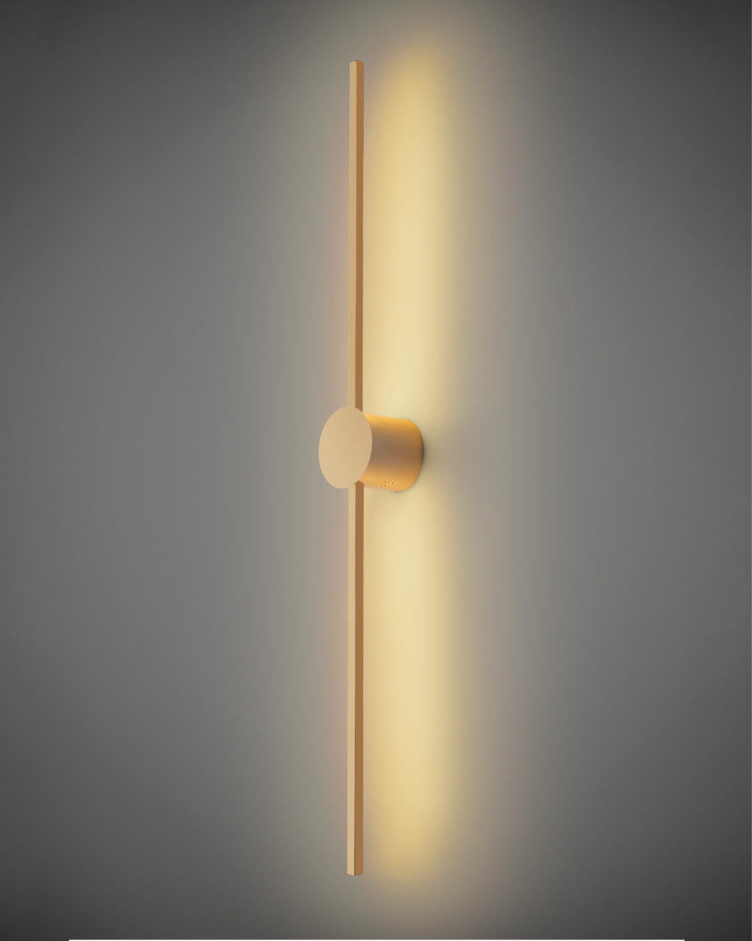 Gold wall lamp with double vertical lines and central circle casting soft indirect light / مصباح حائط ذهبي بخطين رأسيين ودائرة مركزية يبعث إضاءة غير مباشرة ناعمة