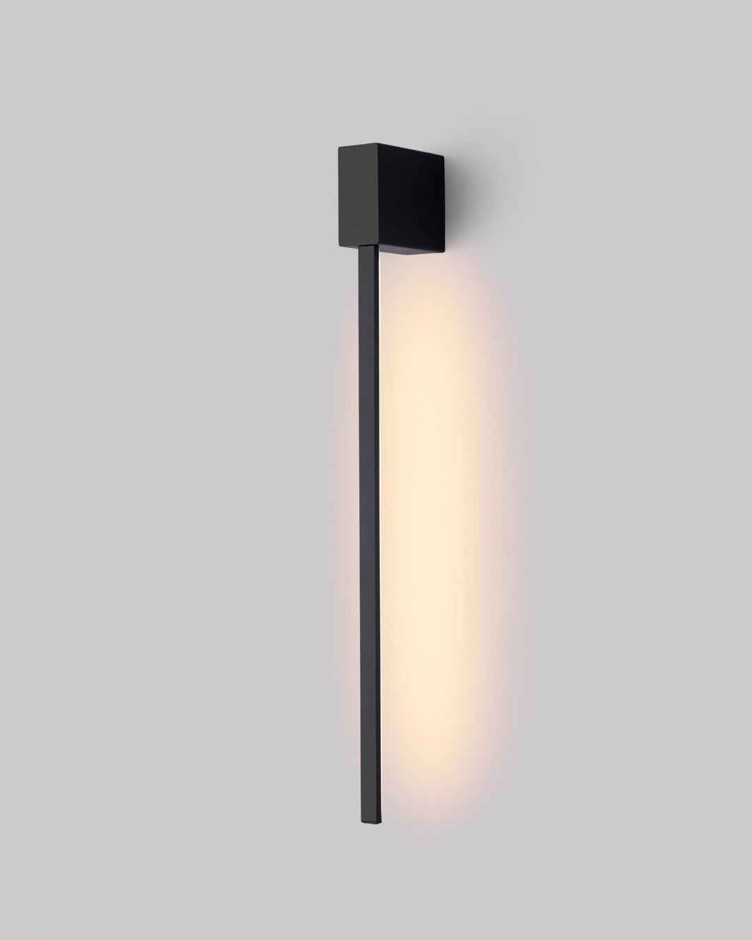 Black square wall lamp with linear design casting soft indirect light / مصباح حائط أسود مربع بخطوط هندسية يبعث إضاءة غير مباشرة ناعمة