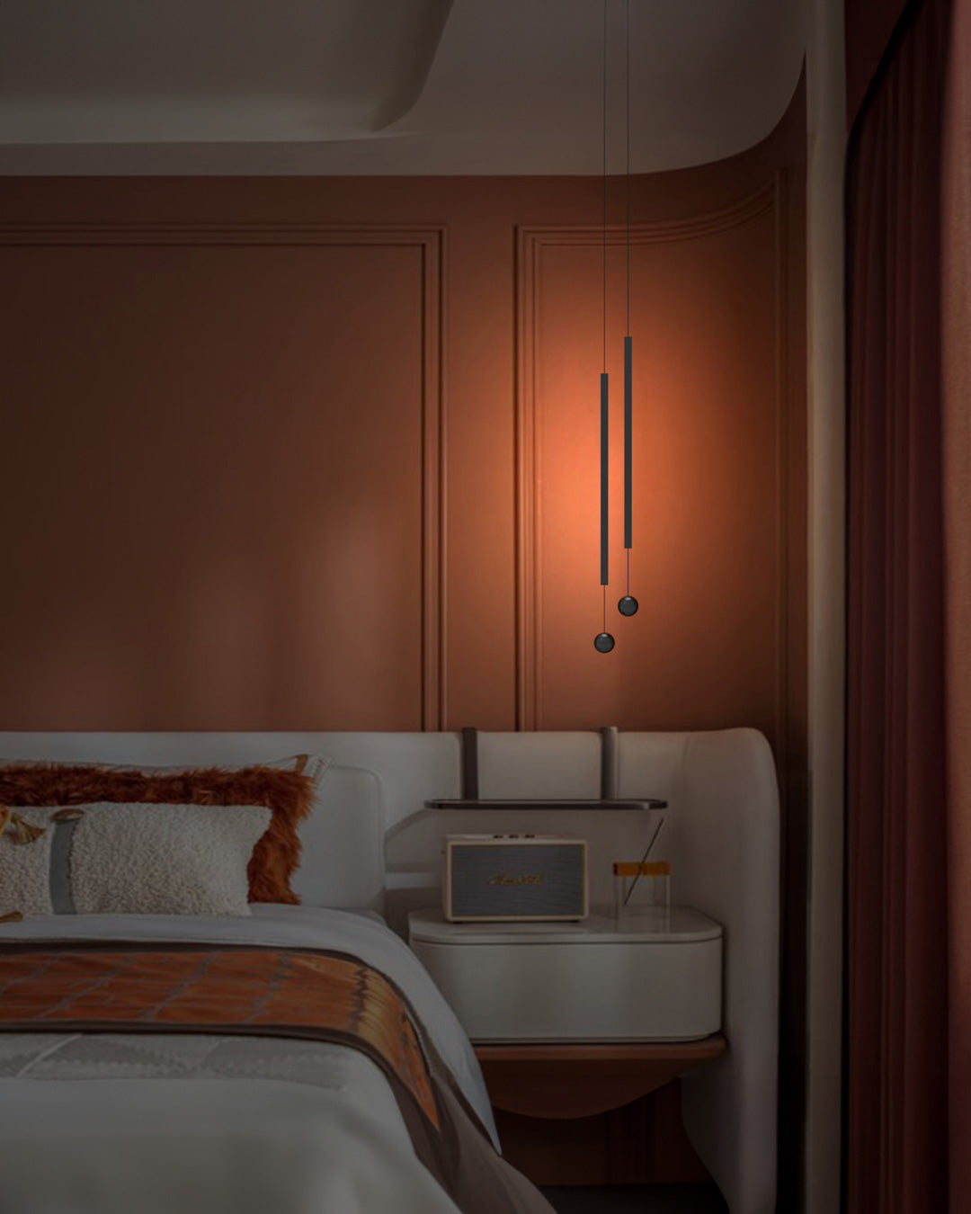 Two lines pendant light with slim vertical black rods creating warm ambient lighting / إضاءة معلقة بخطين بتصميم طولي نحيف باللون الأسود تضيف إضاءة دافئة وعصرية