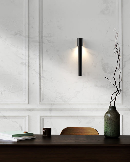 Dew inspired wall lamp with soft glowing glass form on a modern wall / مصباح حائط بتصميم مستوحى من قطرات الندى يبعث إضاءة ناعمة على الجدار