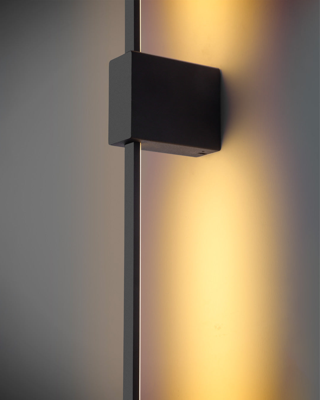 Black square wall lamp with double linear design casting soft indirect light / مصباح حائط أسود مربع بتصميم خطي مزدوج يبعث إضاءة غير مباشرة ناعمة
